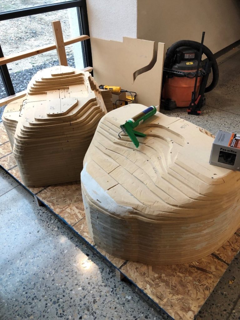 The beginning layer of Bondo applied to the car - some grinding completed. The front portion of the car is in the foreground.