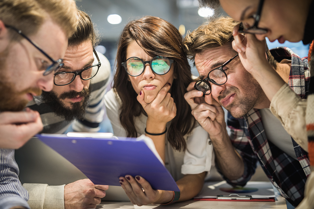 high school students looking at a notepad