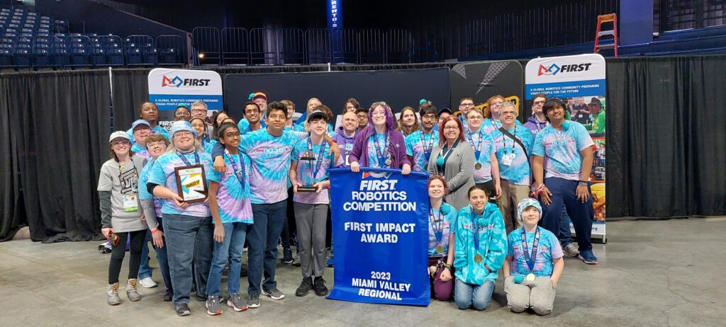 Student team Lakota Robotics holds up their Impact award