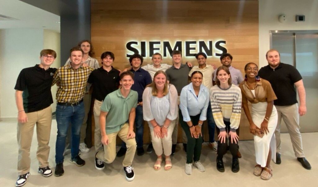 A group of interns smile for a picture.