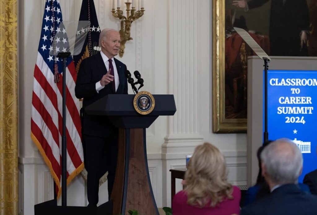 President Joe Biden addresses a crowd in the White House.