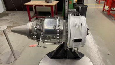 A turbojet engine is displayed as a teaching aid for students.