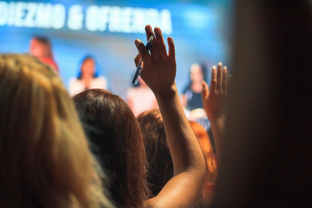 Woman raising her hand with a question at a business conference