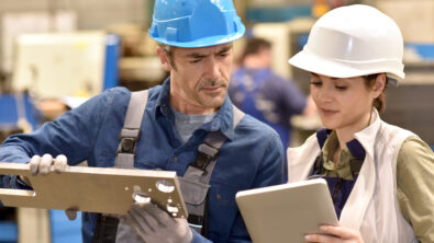 two technicians look at technical documentation