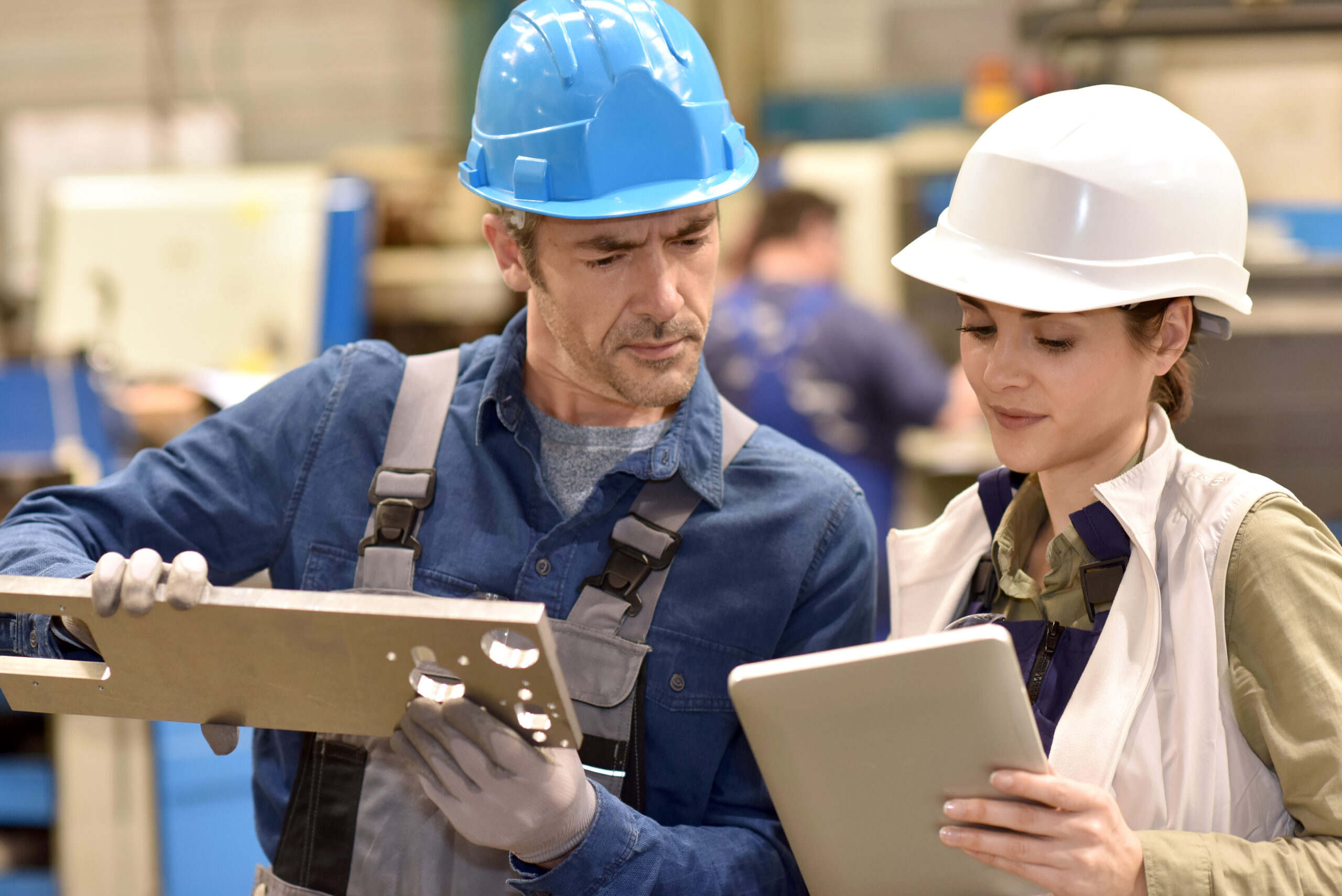 two technicians look at technical documentation