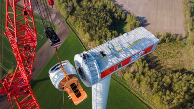 Workers construct wind turbine