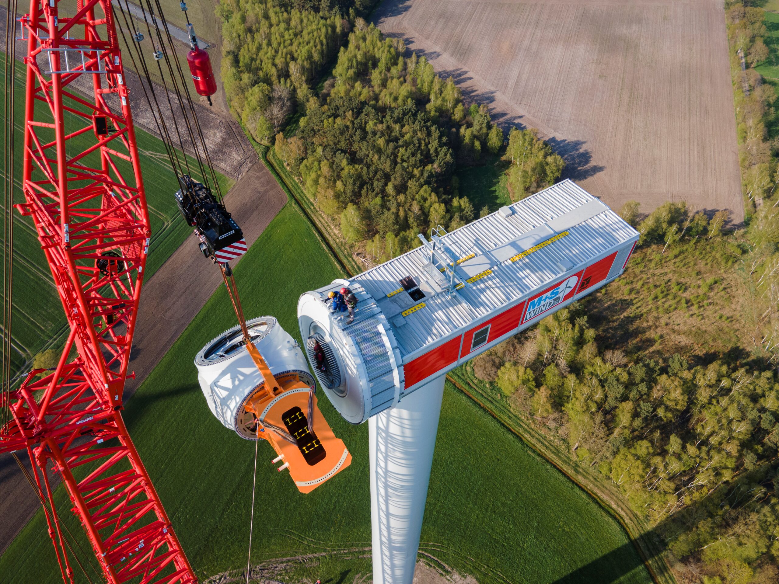 Workers construct wind turbine