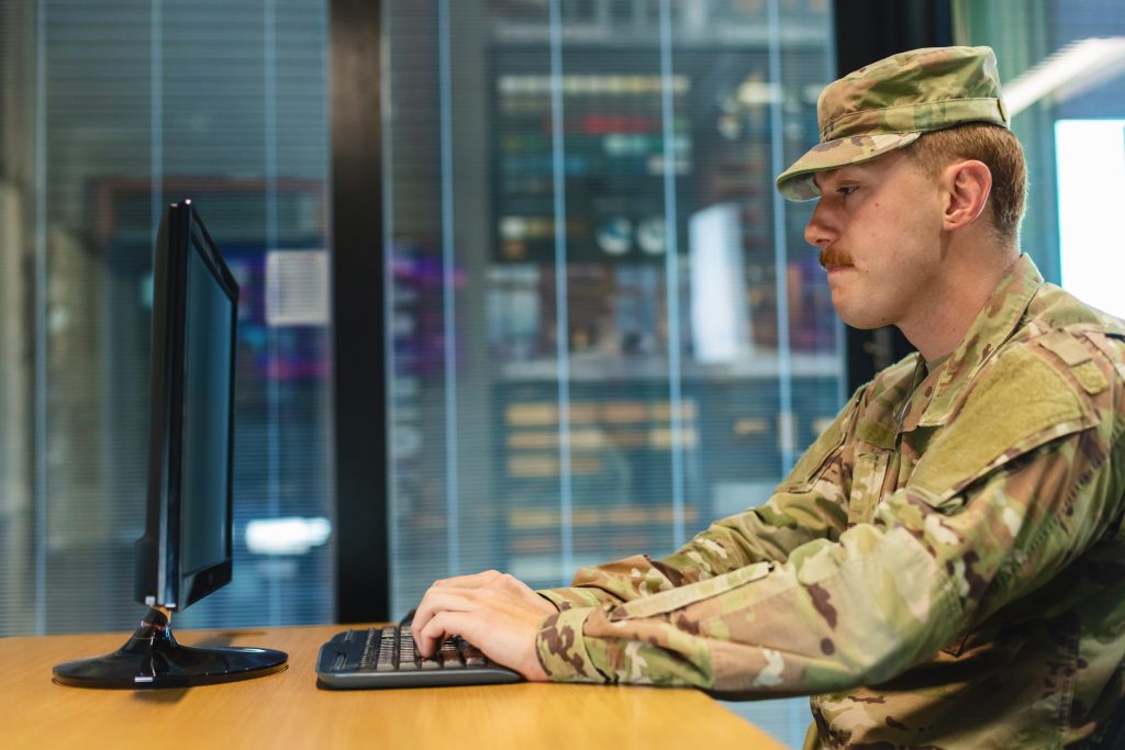 Military personnel working on computer