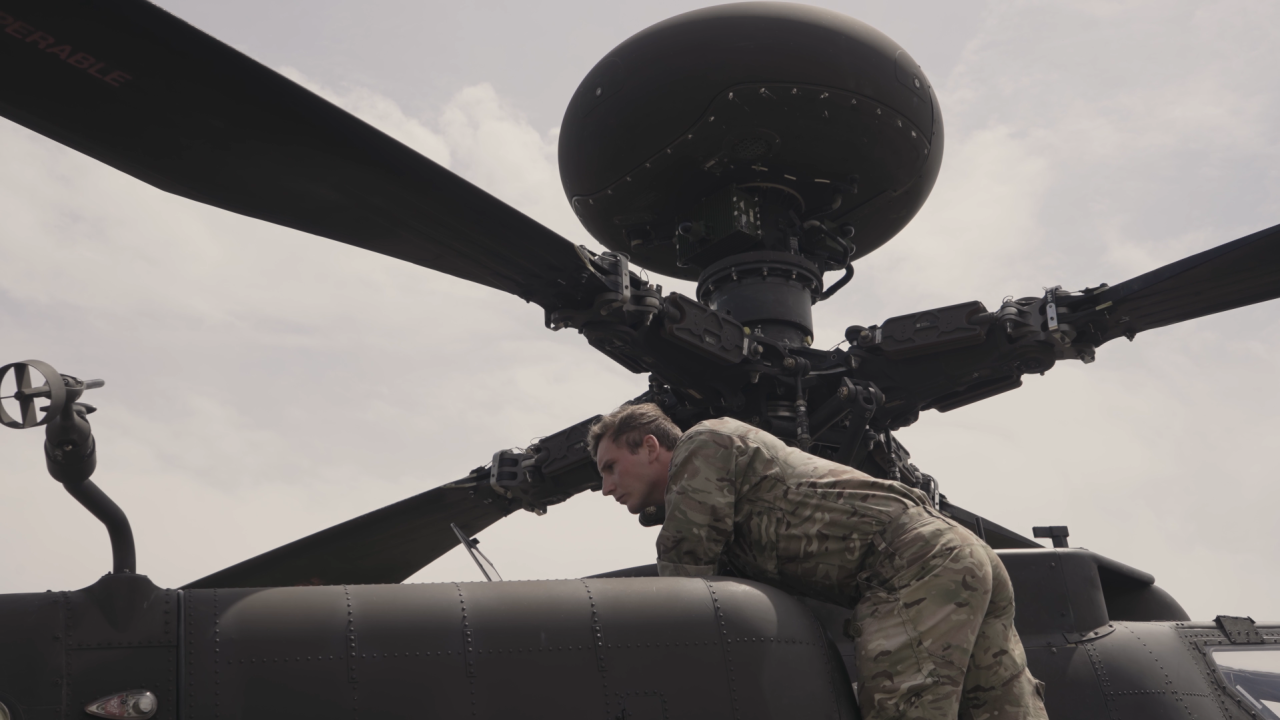 Man inspecting helicopter to support MBSE digital twin for reliability analysis
