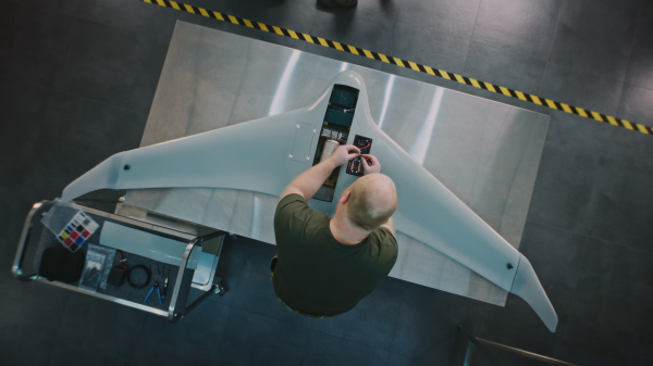 Man working on drone aircraft to support MBSE digital twin for reliability analysis