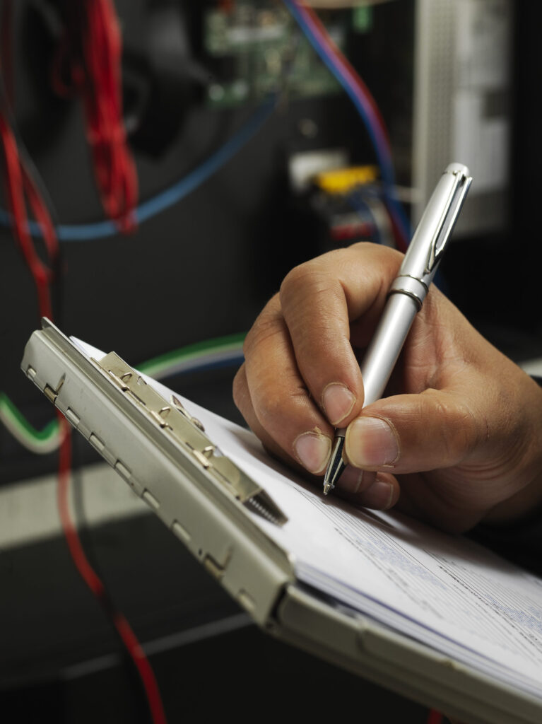 Engineer on shop floor uses paper manufacturing documentation