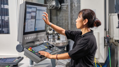 Female engineer uses Sinumerik machine