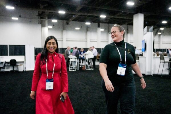 two Realize LIVE attendees walking in the Solution Centre exhibition hall