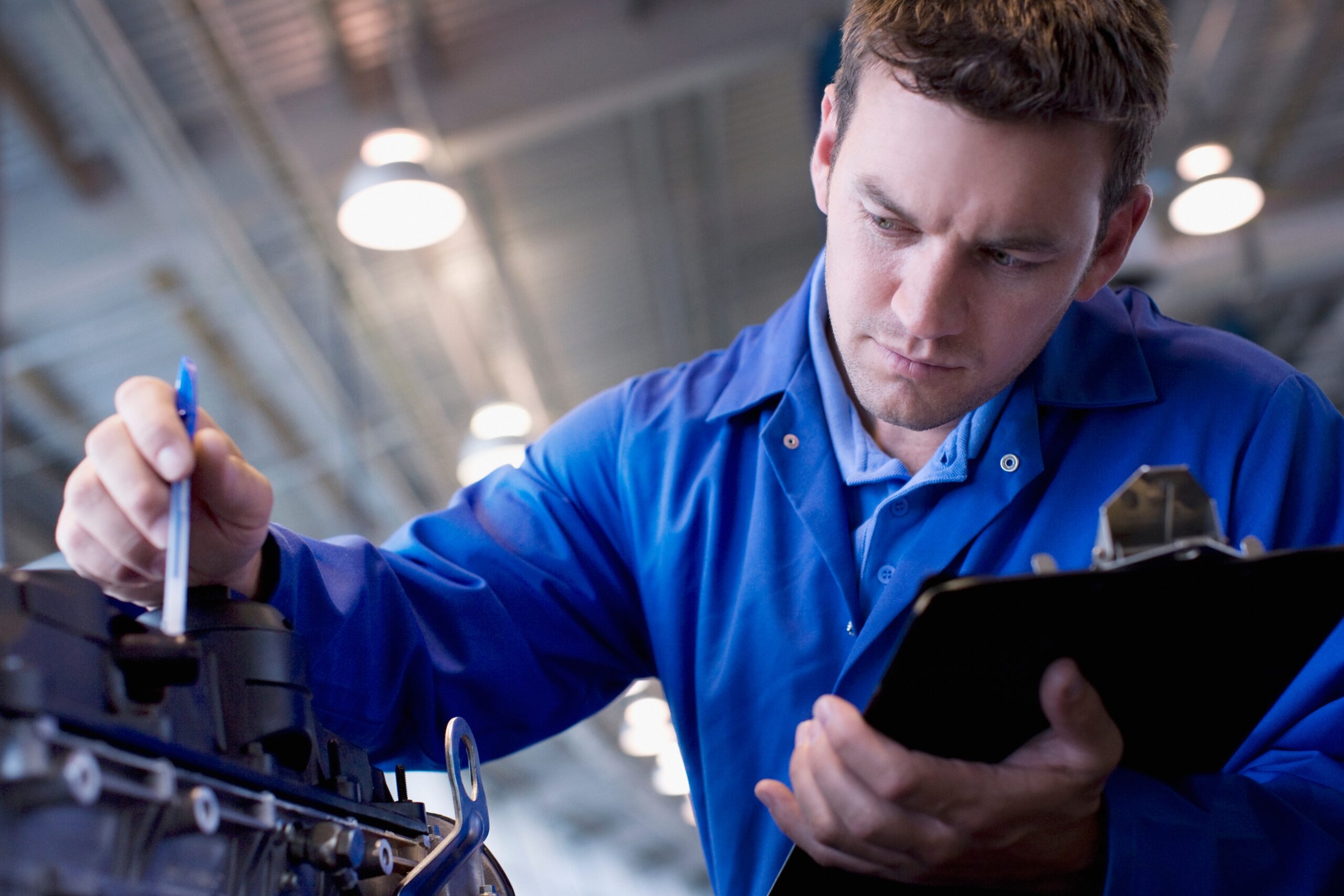 Mechanic checking an engine for repairability with additive manufacturing