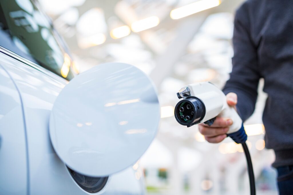 Electric vehicle (EV) plugging in to charge.