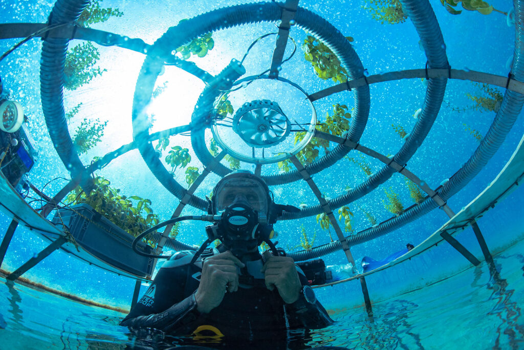 Diver in underwater dome for terrestrial agriculture 