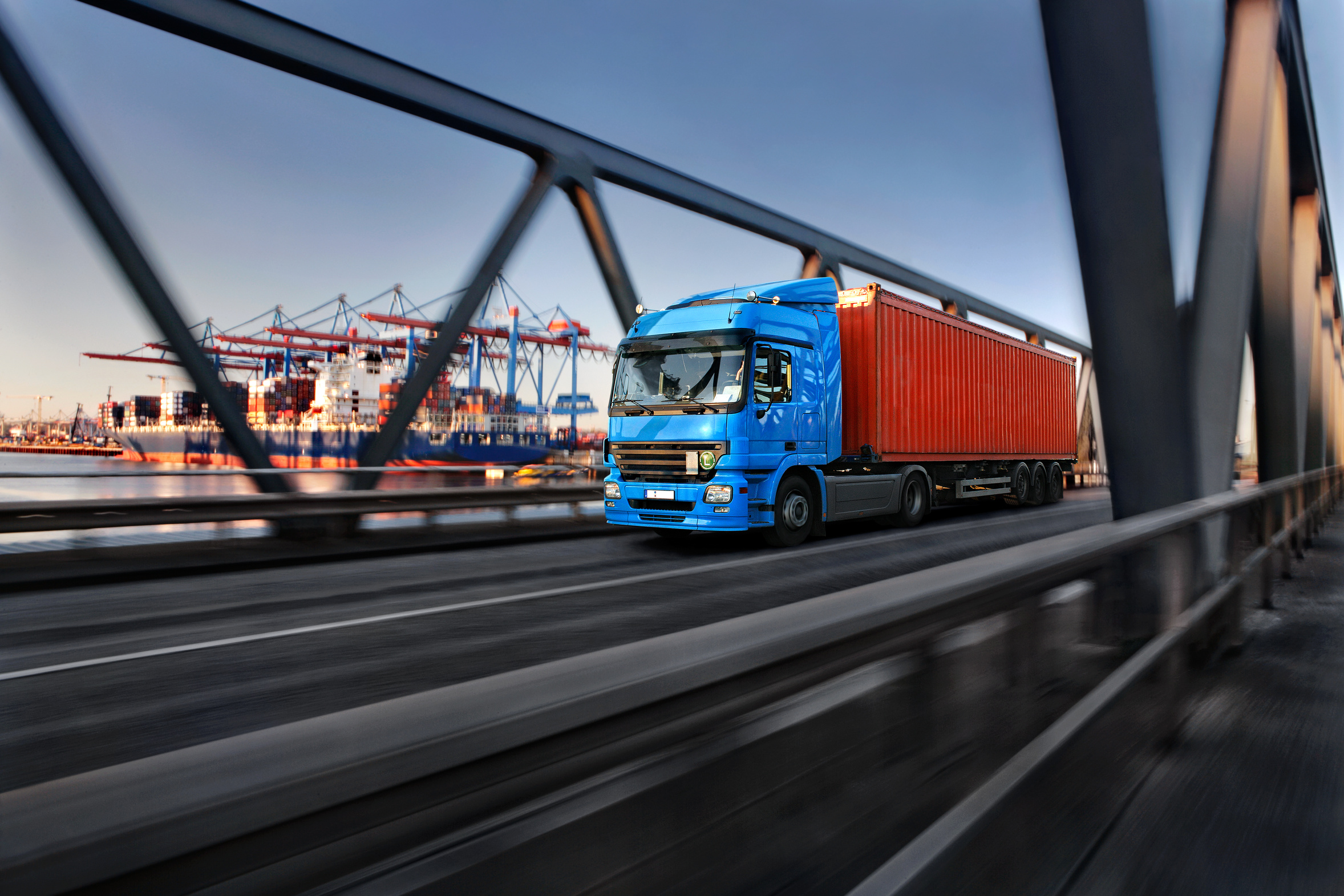 Freight truck leaving a shipping port via a bridge