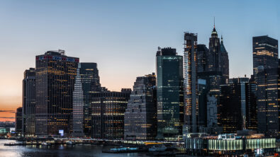 The New York City skyline with a sunset behind it.