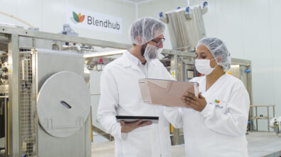 Blendhub test factory in a warehouse, with two technicians observing notes in the foreground