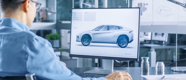 man looking at design on computer