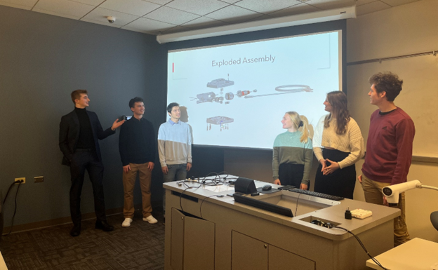 6 University of Cincinnati first-year mechanical engineering students present their exploded assembly of individual handheld jigsaw parts that they reverse engineered in NX CAD