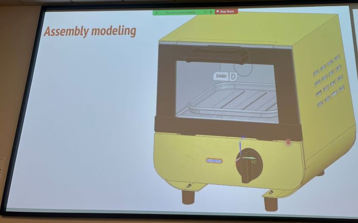 A presentation of the final assembly of a yellow DASH mini toaster oven modeled in NX CAD