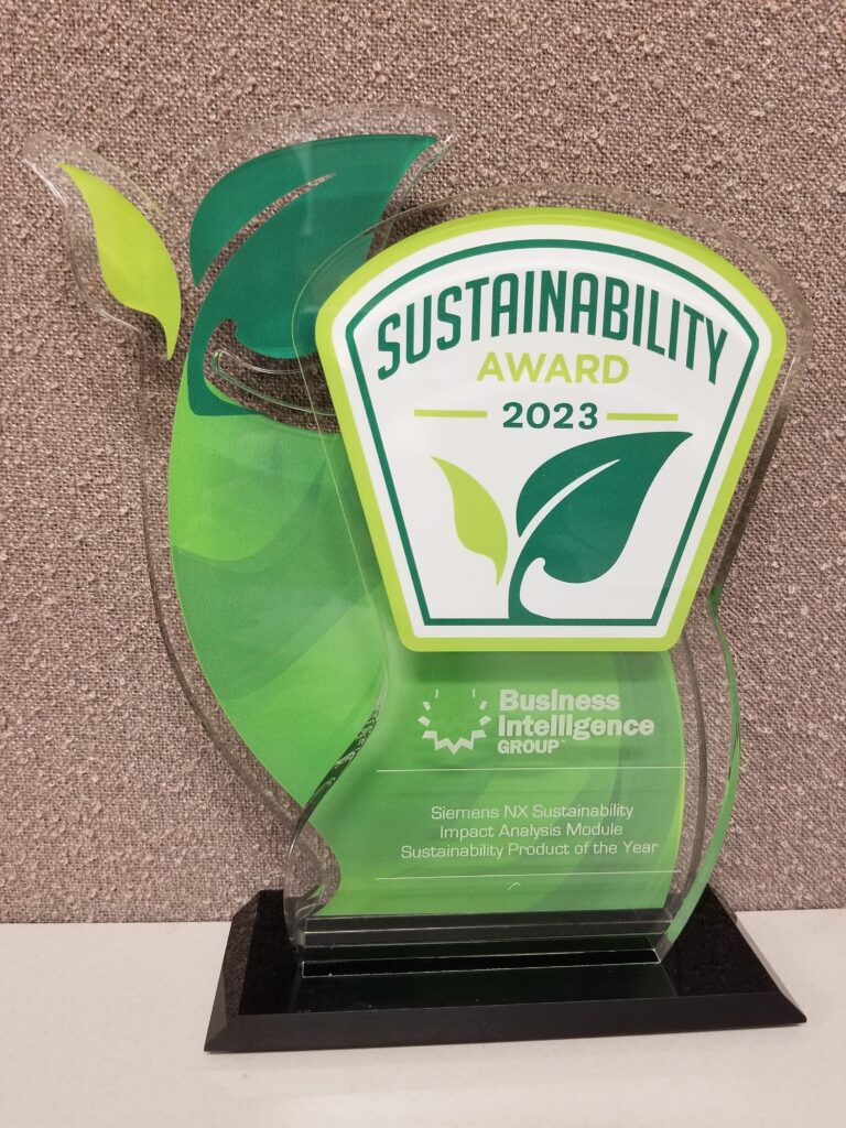 A 2023 Sustainability award that looks like a beanstalk with two leaves; on a desk that reads 'Siemens NX Sustainability Impact Analysis Module, Sustainable Product of the Year' from the Business Intelligence Group