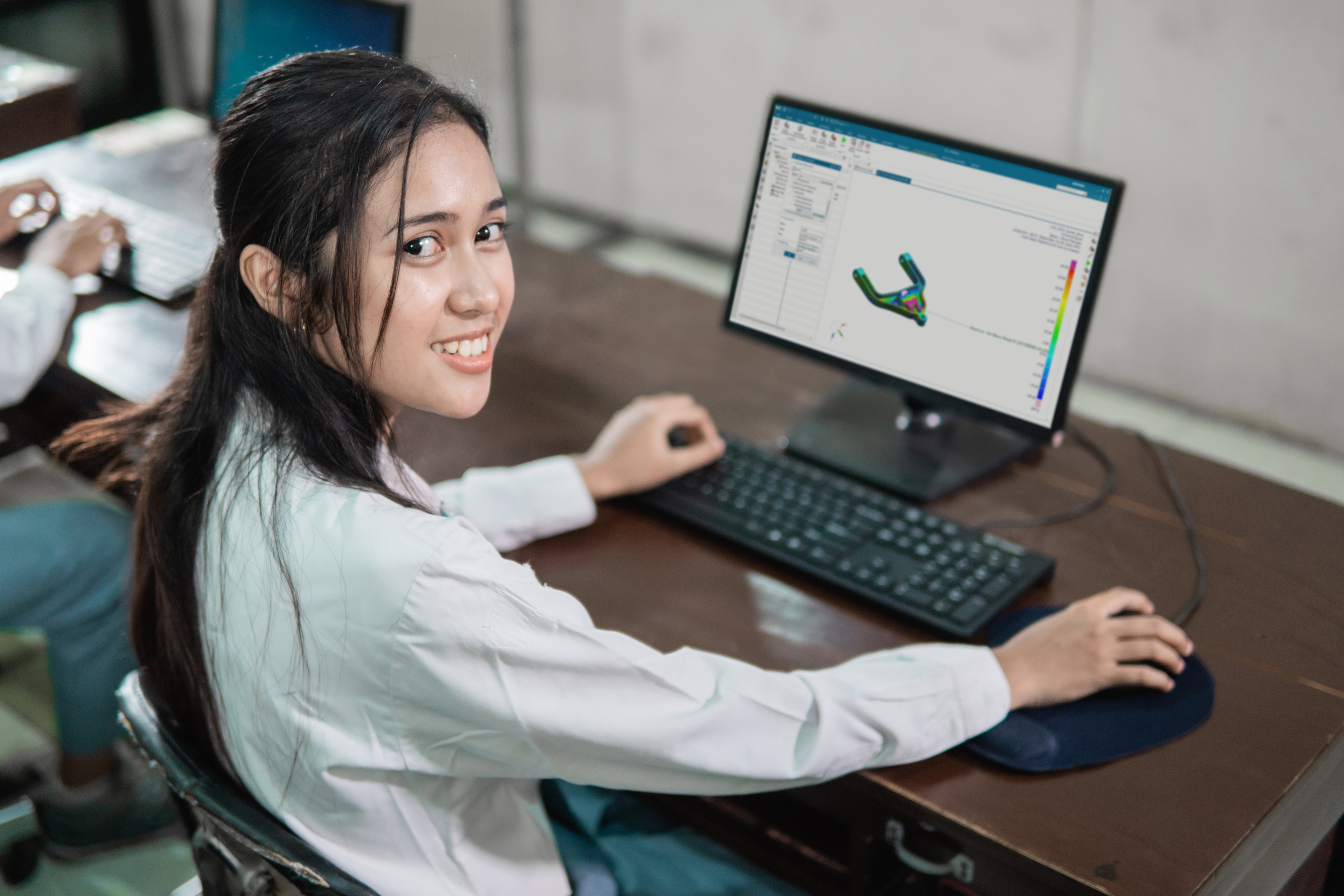 A girl using NX Performance Predictor on NX CAD.
