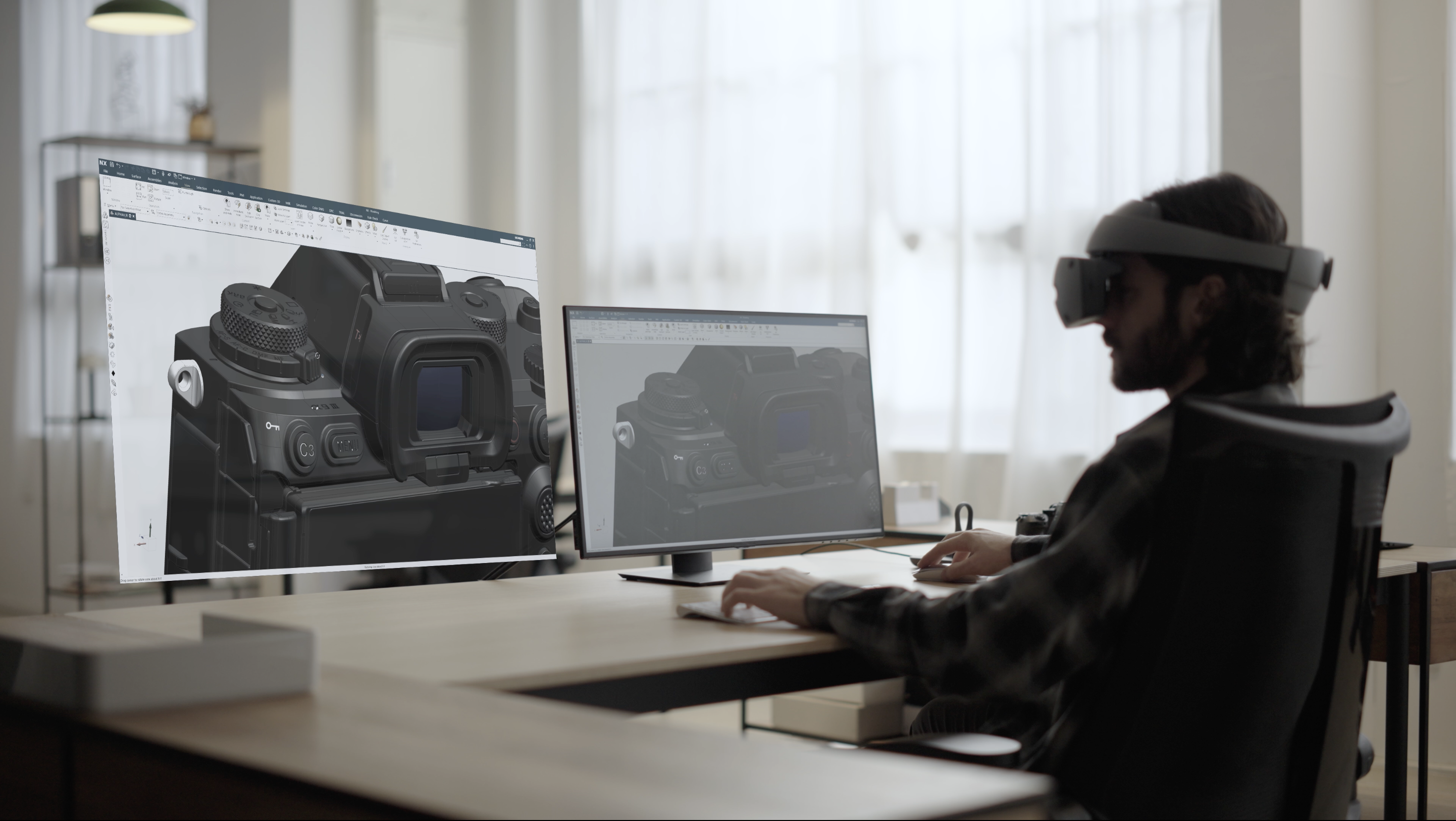 A man wearing a SONY XR head-mounted display while designing a SONY camera on a desktop computer with a virtual reality virtual monitor next to it.