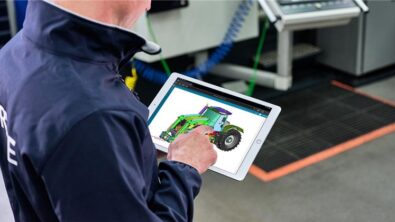 A person on a tablet with the NX X Essentials application open showing a design of a tractor