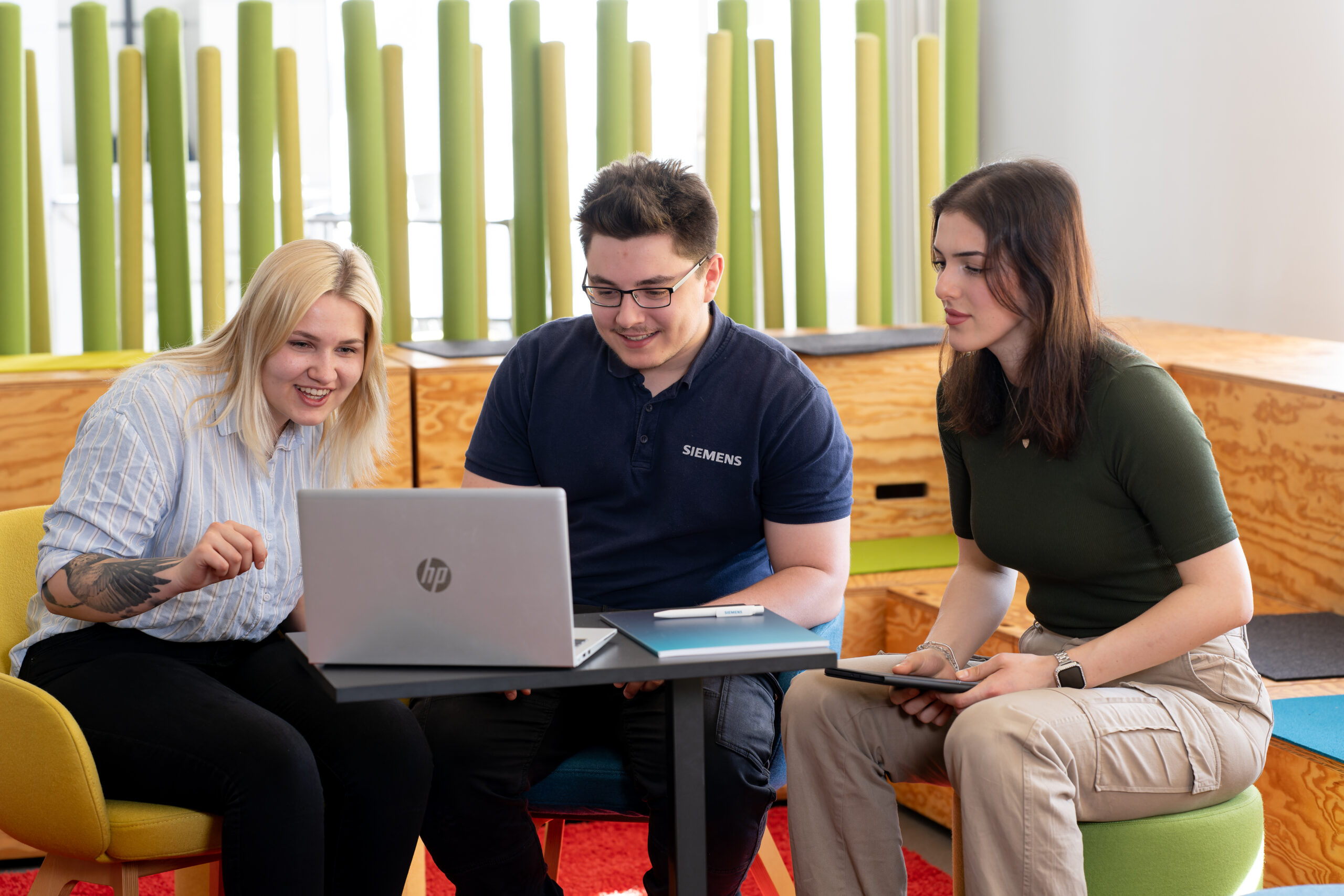 3 students on a laptop
