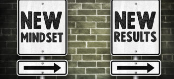 Two signs against brick wall: One New Mindset, other New Results with arrows going same direction