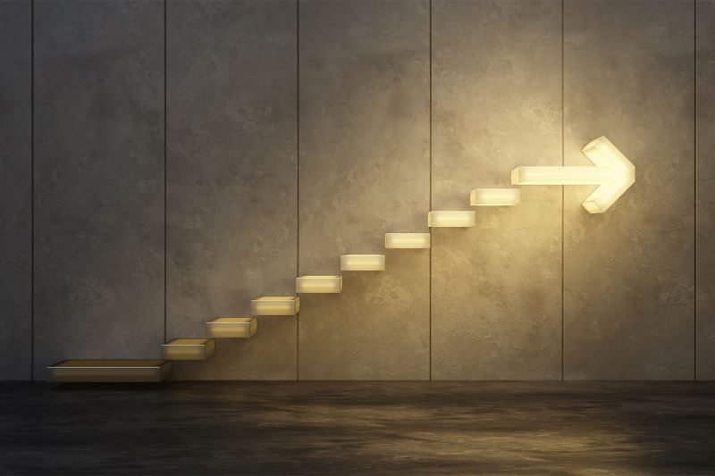 illuminated stairs with arrow