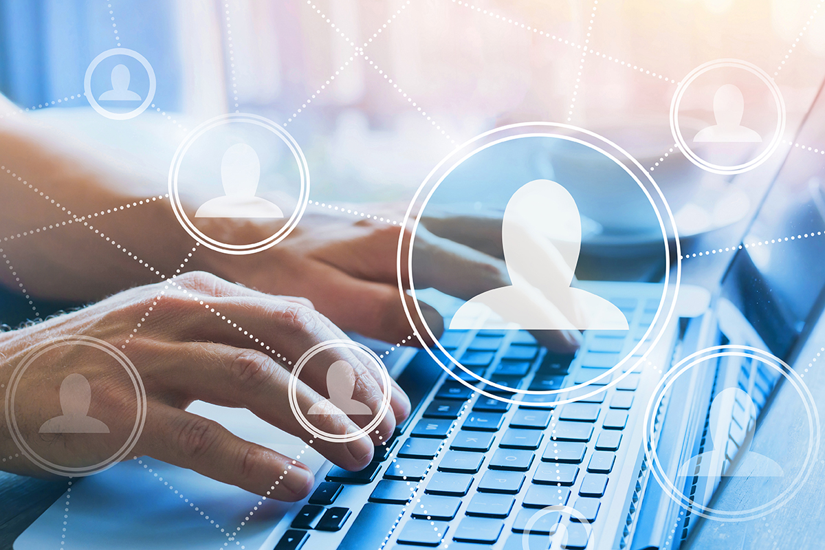 woman typing with digital headshots in circles floating above