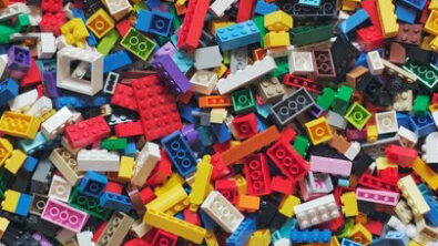 Photo of multi-colored toy building blocks, representing the building-block approach offered in a flexible low-code approach to Sustainability and ESG.