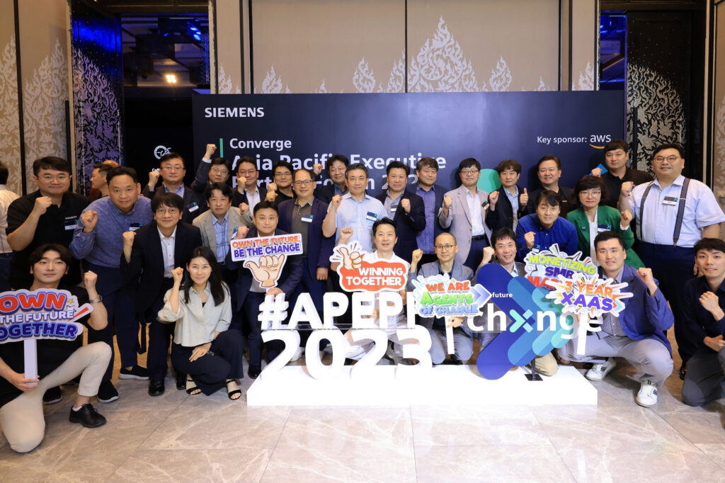 A group of Converge attendees pose with signage.