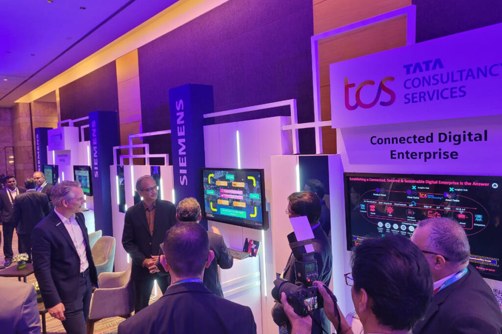 TCS and Siemens booths side by side at a trade show. TCS recently established a COE that showcases Siemens technology.
