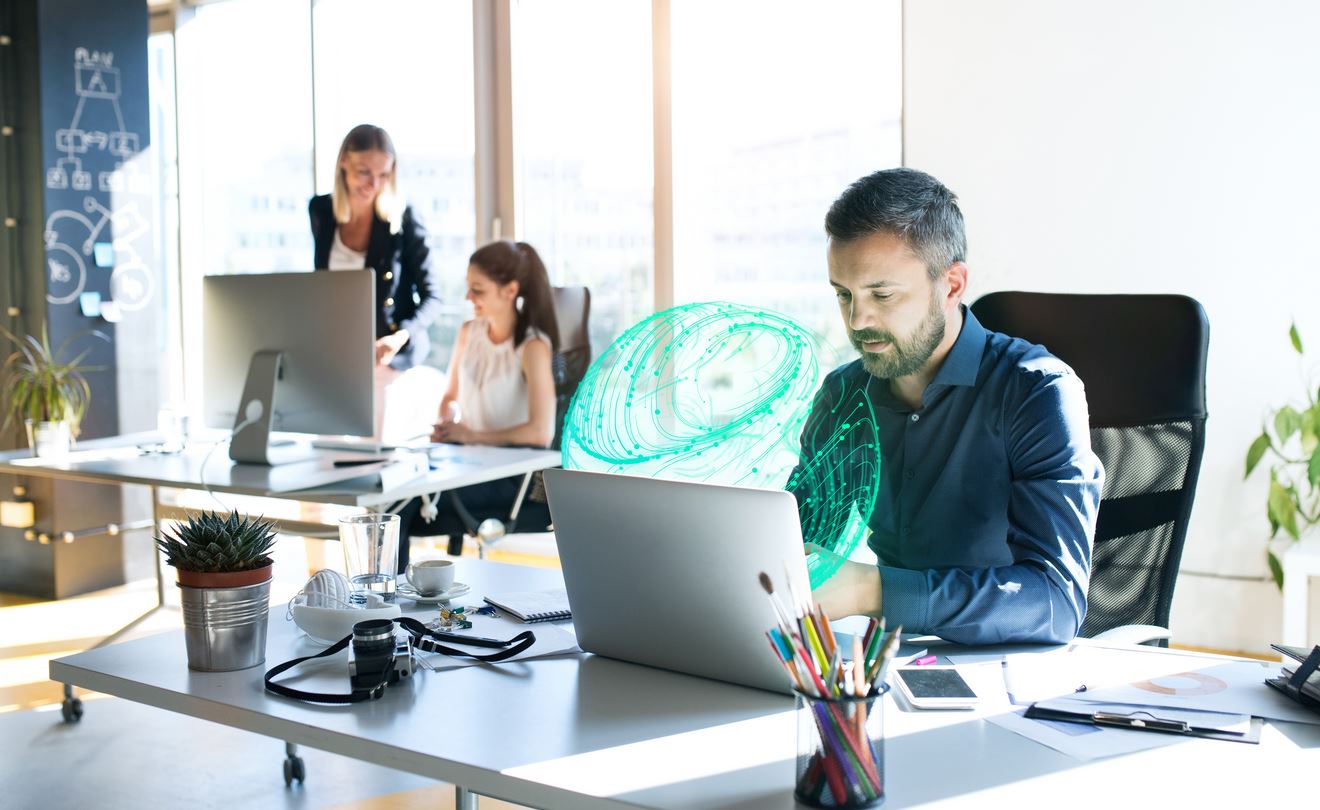 man sitting at a desk working on embedded software