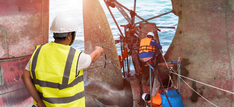 Workers performing maintenance on a ship