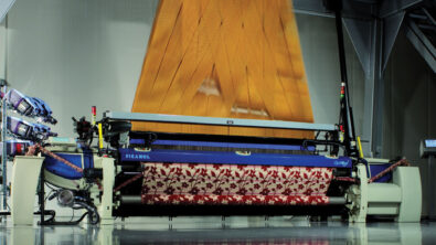 A weaving loom machine in operation