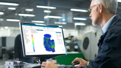 An engineer uses simulation to analyze an industrial machine component.