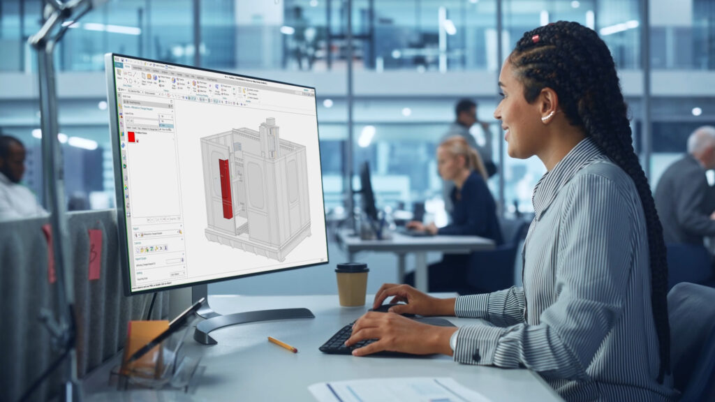 An engineer looks at the digital twin of an industrial machine with PLM for machine builders