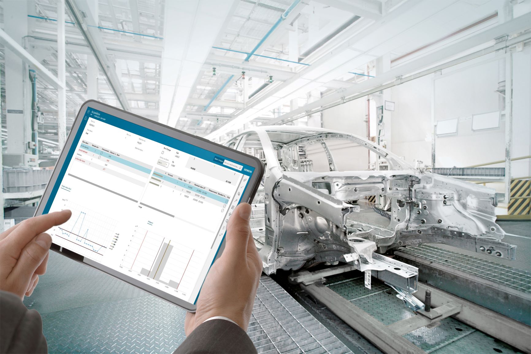 automobile assembly worker reviewing supplier quality management data on a tablet