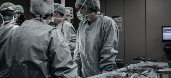 Doctors in an operating room using high quality medical device equipment