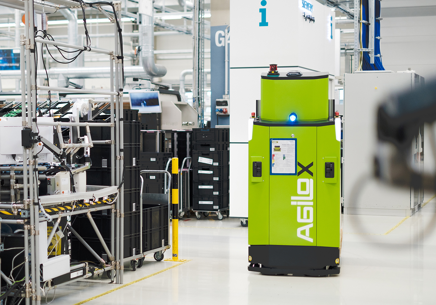 an automated guided vehicle (agv) navigates a lights-out factory