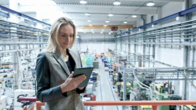 woman in a factory using integrated software for supply chain convergence