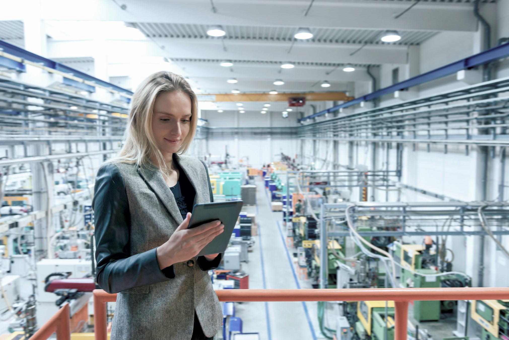 woman in a factory using integrated software for supply chain convergence