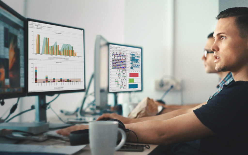 Guy sitting at a pc looking at Opcenter APS