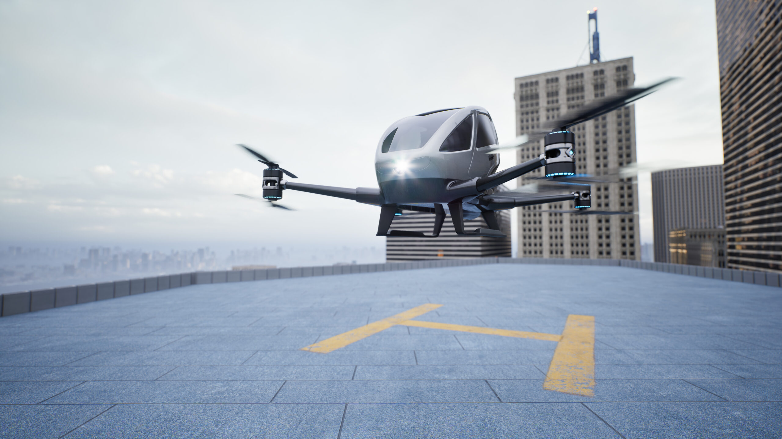 An autonomous advanced air mobility vehicle landing on a rooftop helipad.