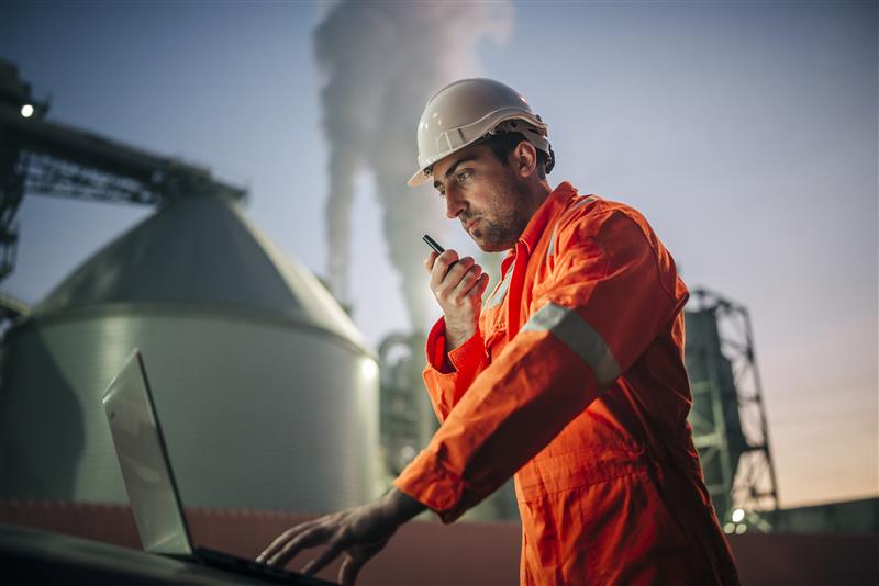 Engineer on site at a power plant using engineering and simulation software